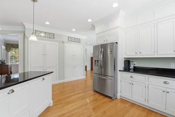 a kitchen with granite countertop a refrigerator and a sink