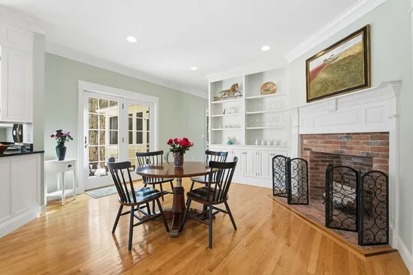 a view of a dining room with furniture and a fireplace