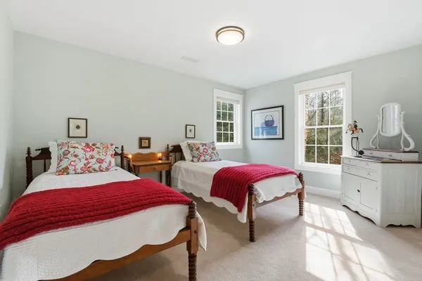 a bedroom with three beds and a window