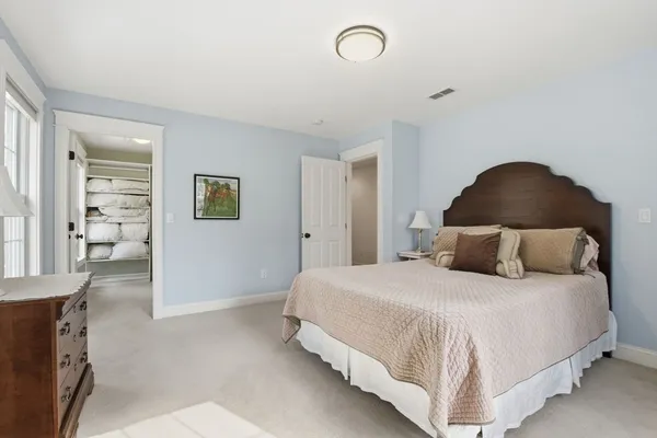a bedroom with a bed and painting on the wall