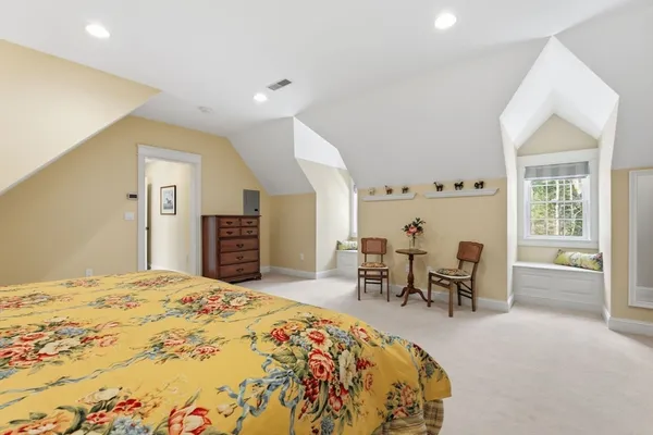 a bed room with a bed and a chair