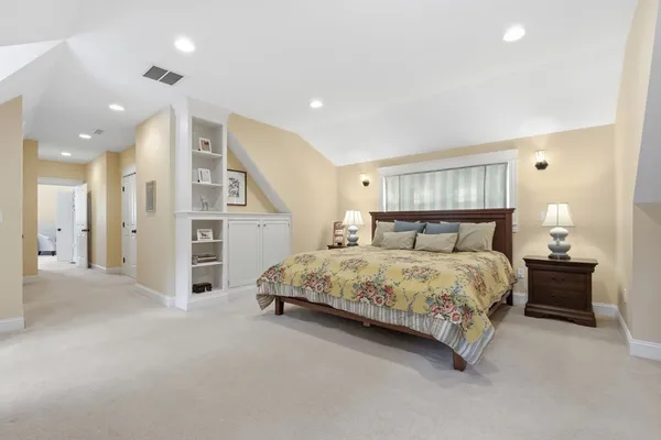 a spacious bedroom with a bed and a walk in closet