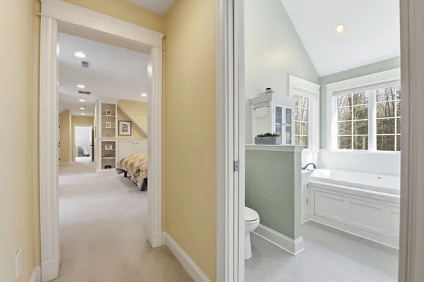 a bathroom with a tub sink and mirror