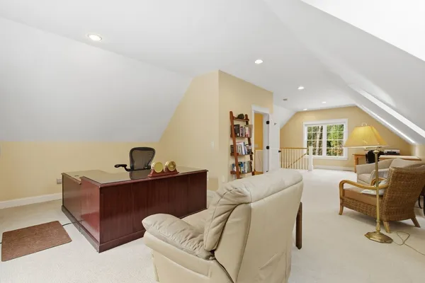 a living room with furniture and a piano