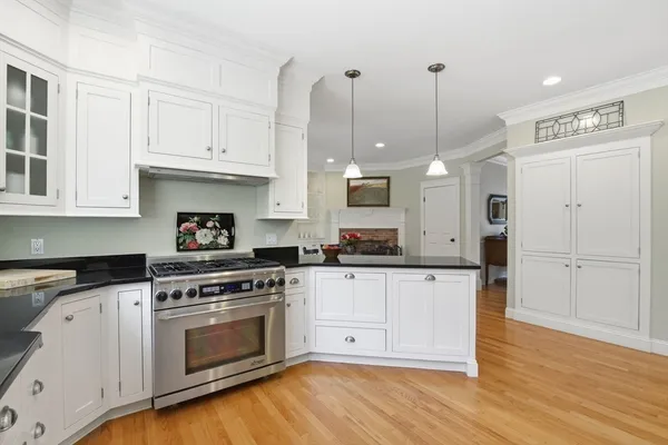 a kitchen with white cabinets and white appliances