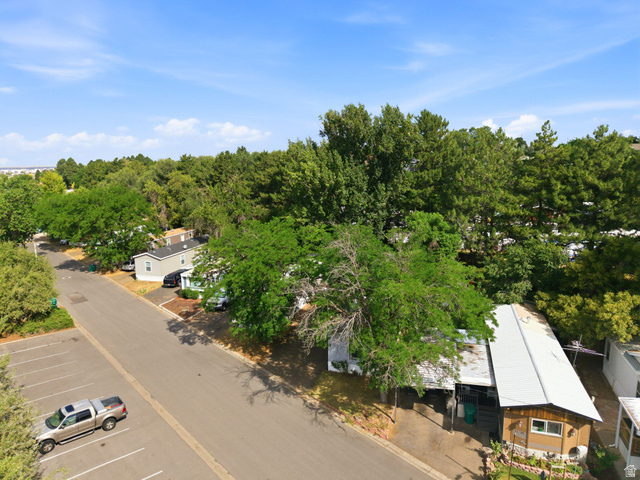 2875 North Hill Field Road, Unit 62 Layton, UT 84041 - Photo 30 of 34 Aerial perspective showcasing a residential community with abundant mature trees and paved roadways