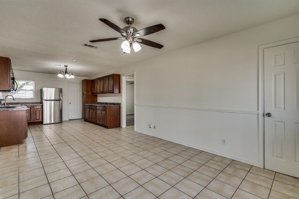 116 North 12th Street, Unit B Midlothian, TX 76065 - Photo 24 of 24 a large kitchen with a stove cabinets and stainless steel appliances