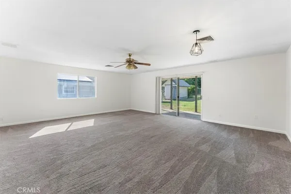 an empty room with a empty space and windows