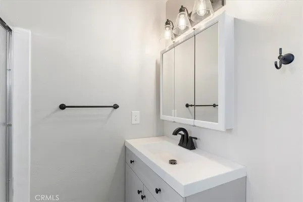 a bathroom with a sink vanity and mirror