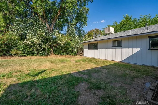 a house with green field in front of it