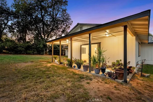 a view of a house with backyard porch and sitting area