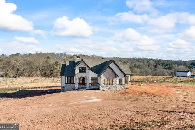 a view of white house with a yard