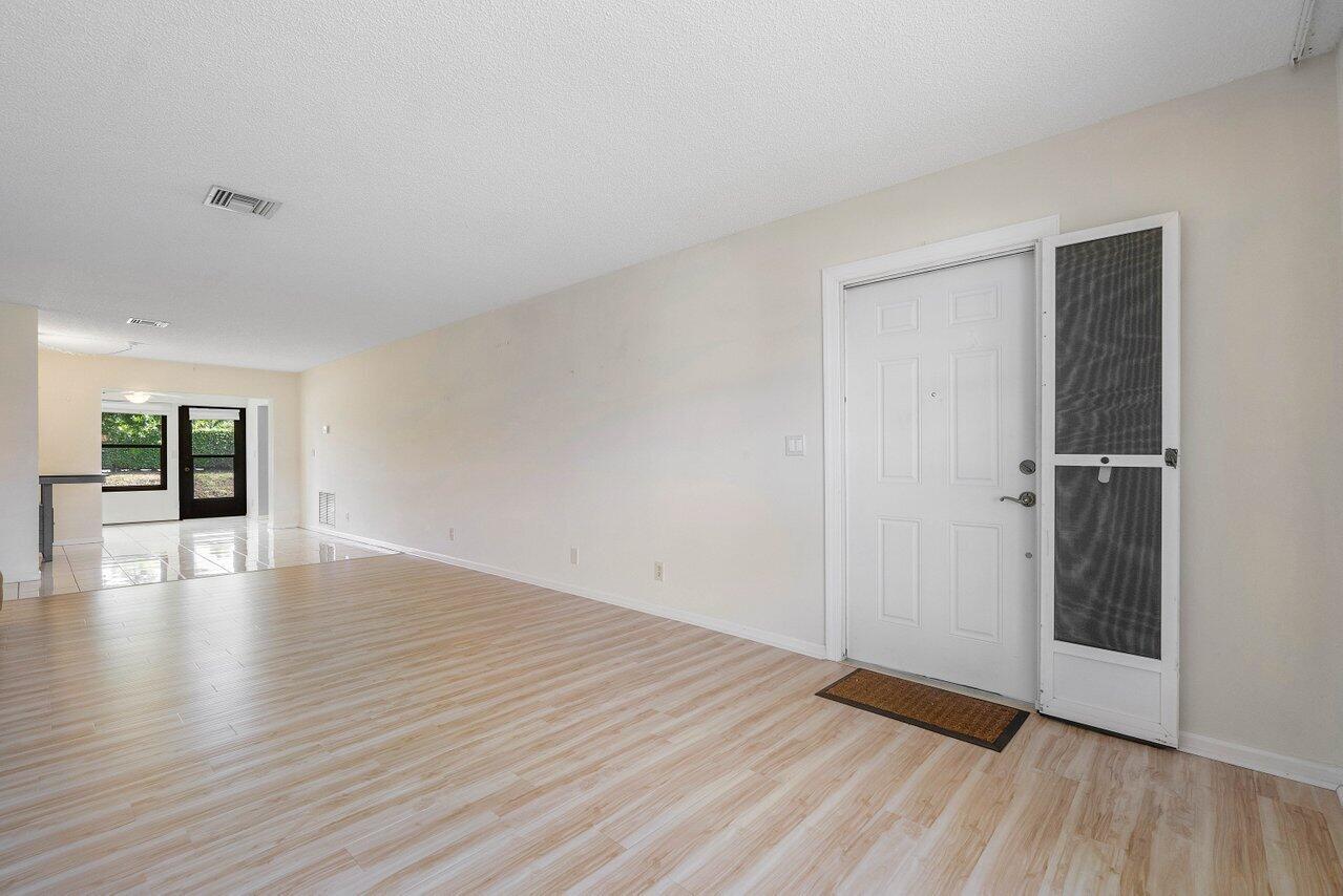 4495 Pandanus Tree Road, Unit A Boynton Beach, FL 33436 - Photo 2 of 32 Living Room to Dining Room