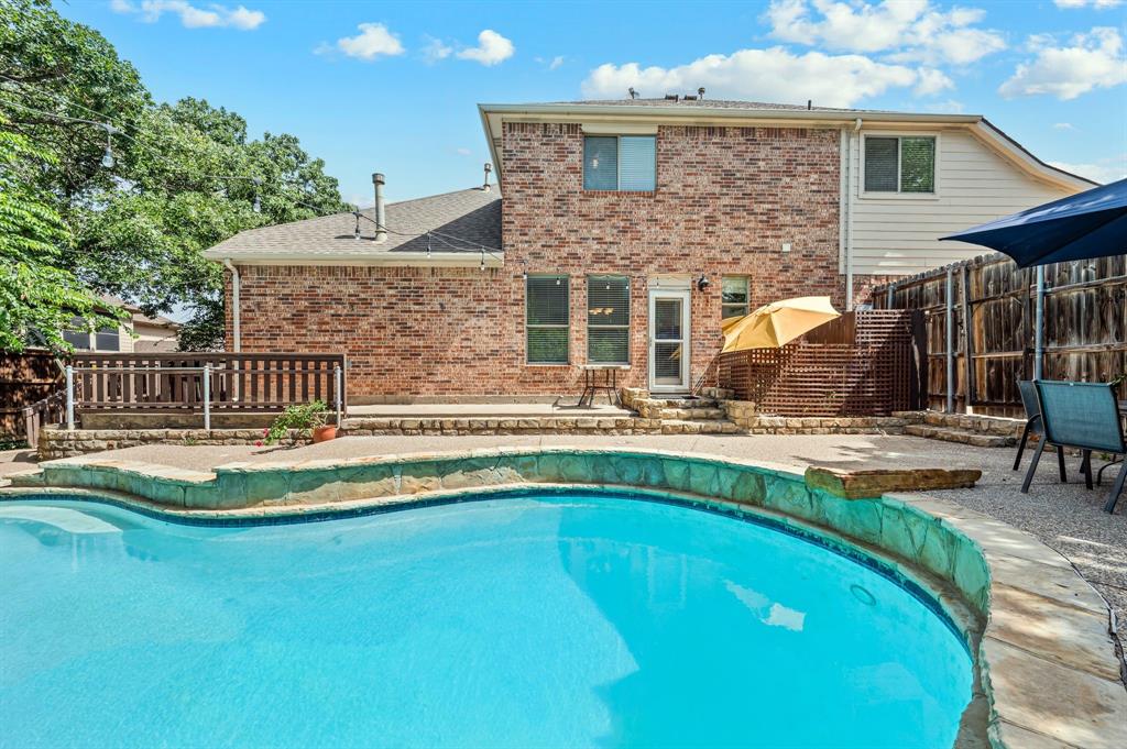 808 Briar Ridge Drive Keller, TX 76248 - Photo 38 of 40 Brick exterior featuring a multi-level patio with a built-in swimming pool