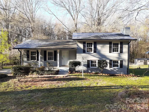 a front view of a house with swimming pool and outdoor seating
