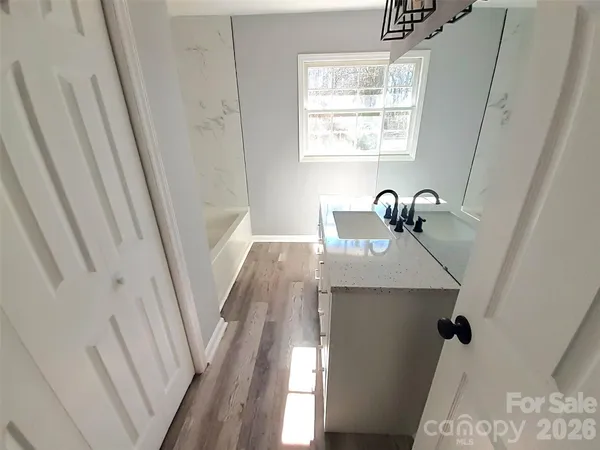 a bathroom with a sink a window and vanity