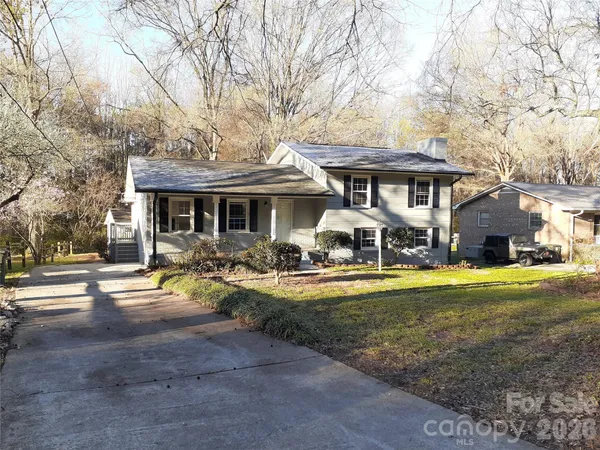 a front view of a house with swimming pool having outdoor seating