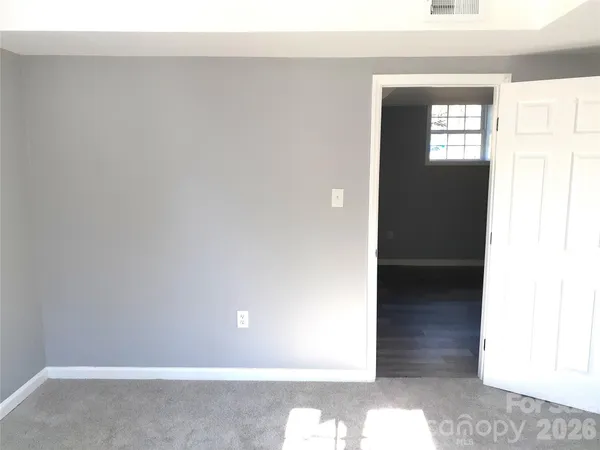 a bathroom with a sink and mirror with bathtub