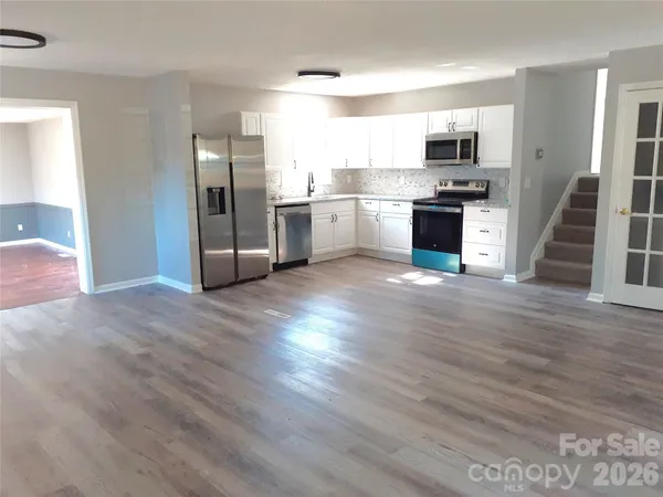 a kitchen with stainless steel appliances a refrigerator and a stove top oven