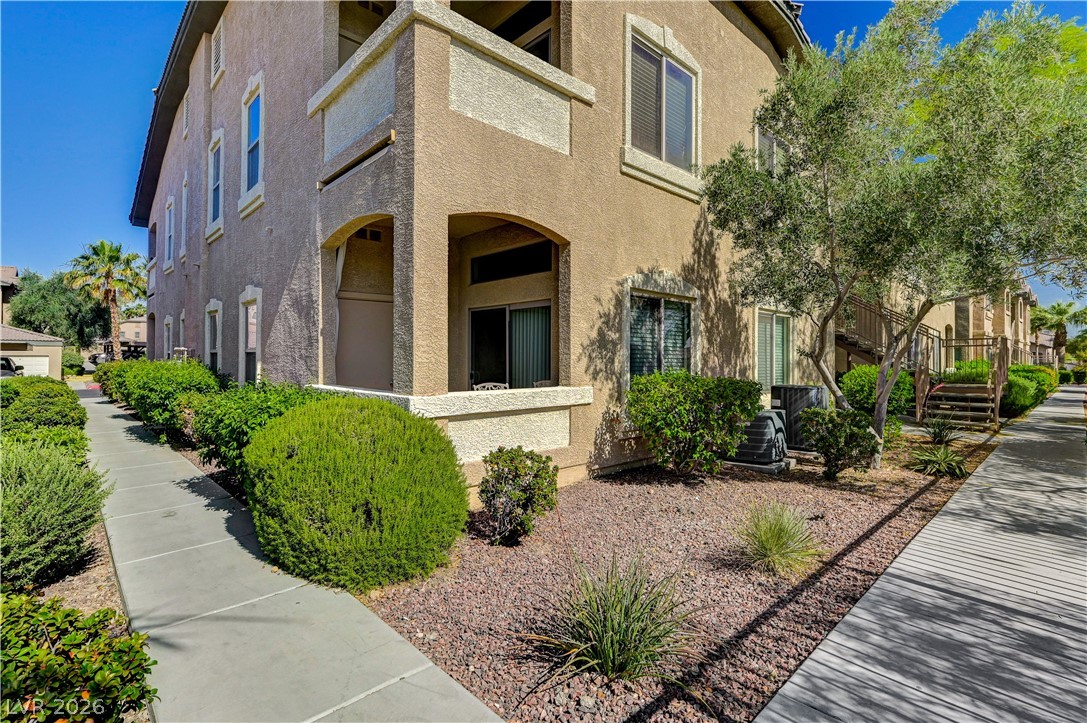 8985 South Durango Drive, Unit 2187 Las Vegas, NV 89113 - Photo 9 of 73 A pleasant walkway leads to this well-kept multi-unit residential building with accessible outdoor space.