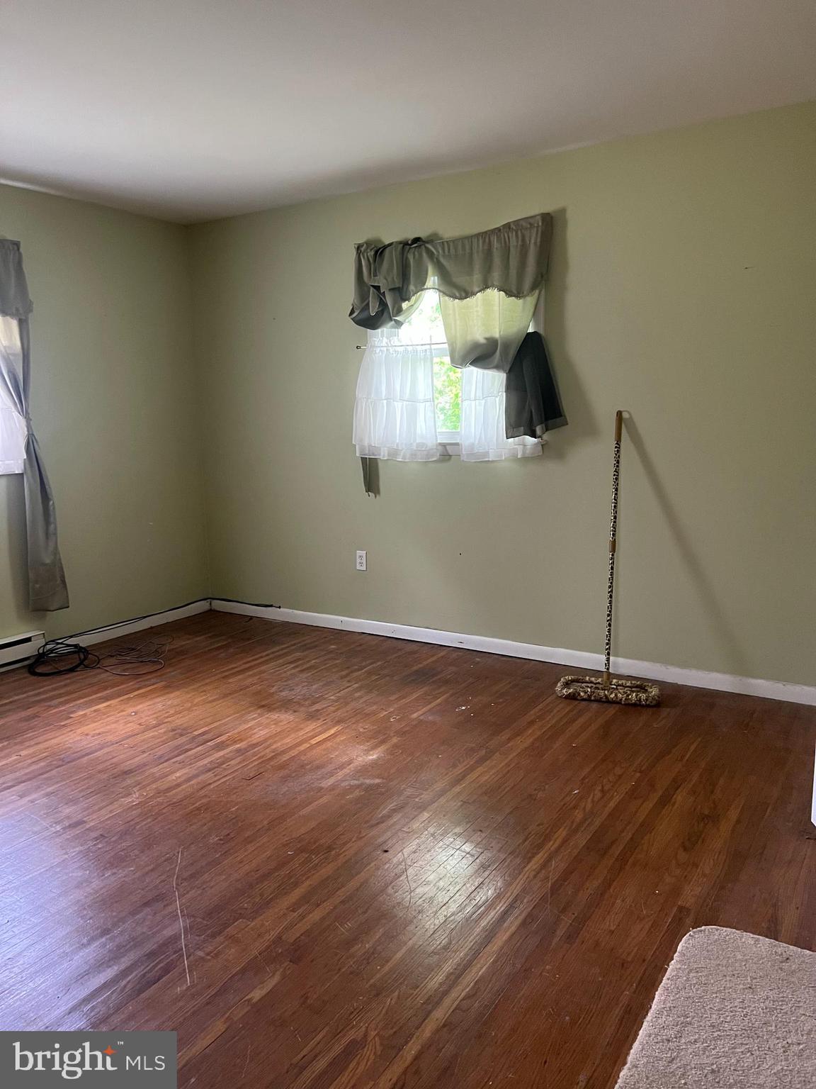 707 Upper Neck Road Pittsgrove, NJ 08318 - Photo 7 of 14 an empty room with wooden floor and windows