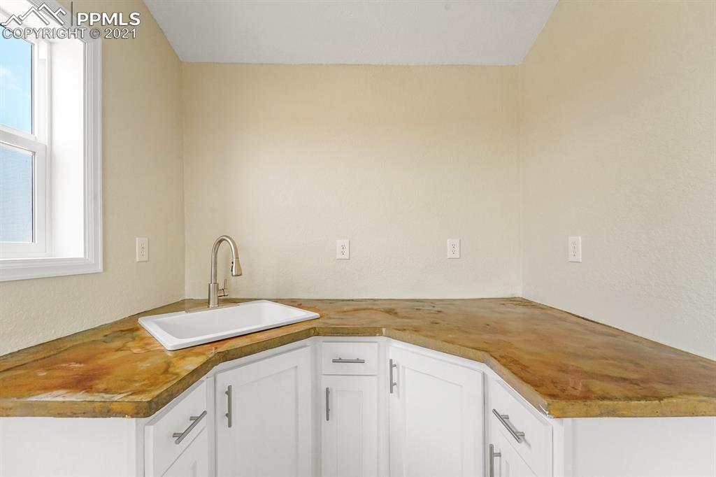 1331 County Road R Rush, CO 80833 - Photo 7 of 22 a view of a kitchen with a sink cabinets and a window