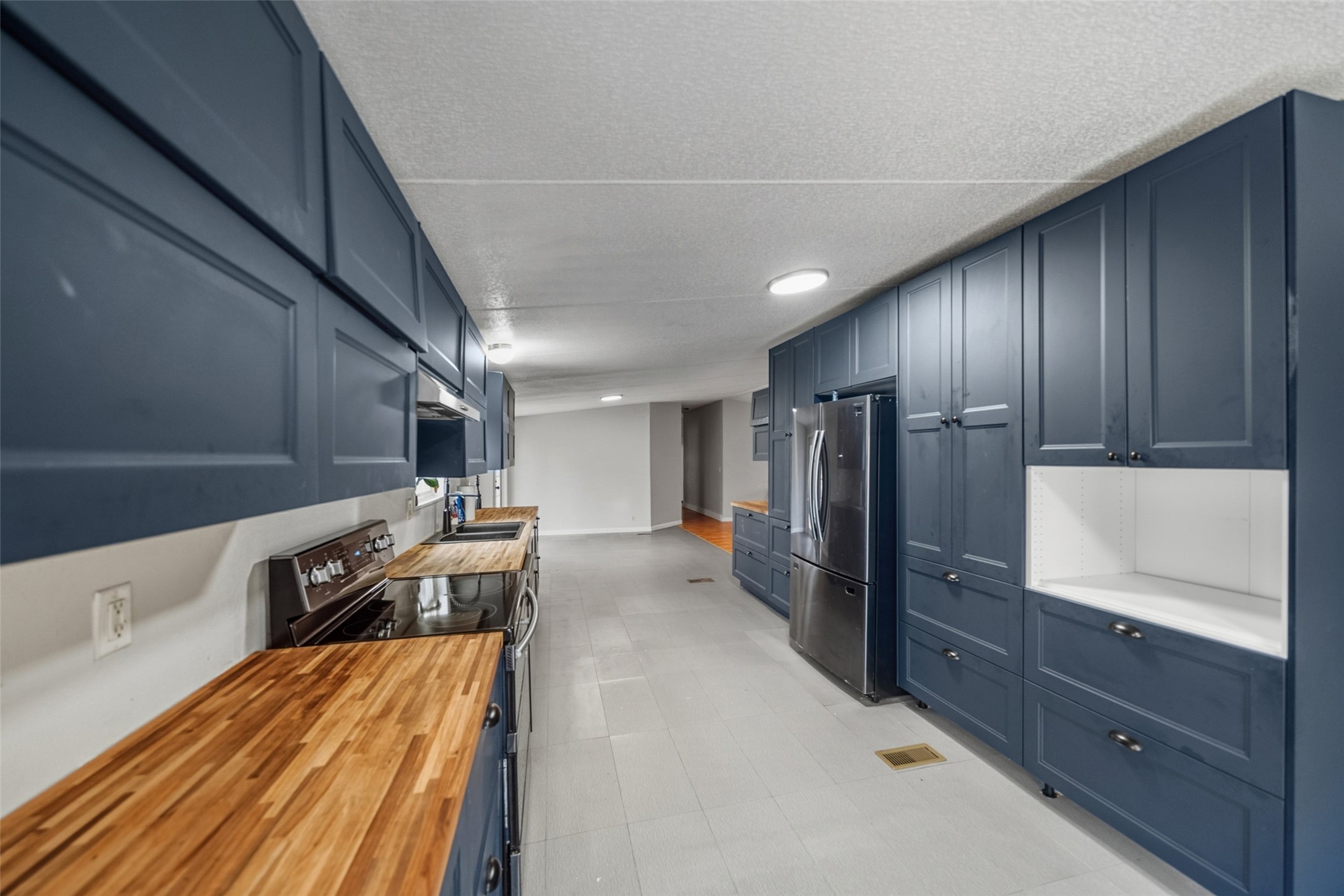 234 County Road 2286 Cleveland, TX 77327 - Photo 5 of 35 Kitchen boasting butcher block counters and ample cabinetry.