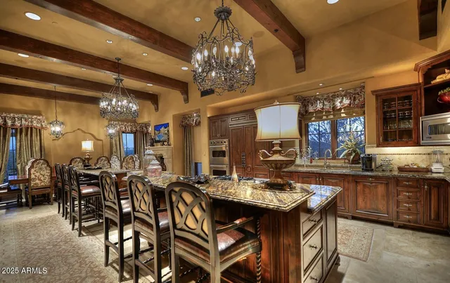 a view of a dining room with furniture and chandelier