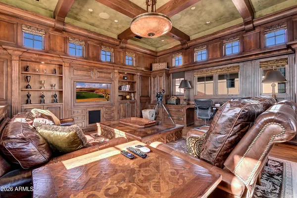 a bedroom with a bed and a dresser next to a window