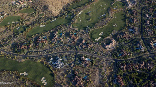 an aerial view of residential house and sandy dunes