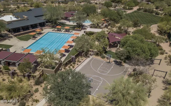 an aerial view of a house with a swimming pool and outdoor space