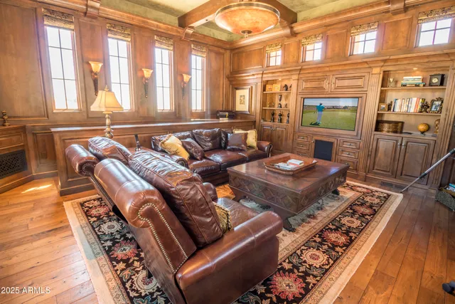 a living room with furniture and a floor to ceiling window