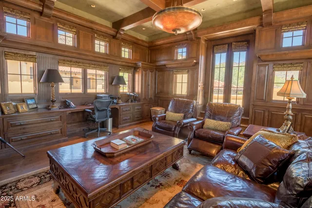 a living room with furniture a large window and a table