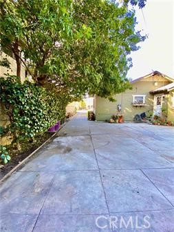 314 Coronado Avenue, Unit C Long Beach, CA 90814 - Photo 15 of 19 a view of a street with potted plants and large trees