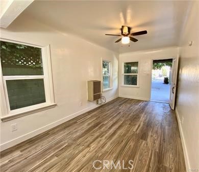 314 Coronado Avenue, Unit C Long Beach, CA 90814 - Photo 3 of 19 a view of a livingroom with wooden floor a ceiling fan and windows