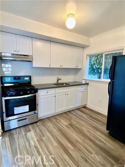 314 Coronado Avenue, Unit C Long Beach, CA 90814 - Photo 6 of 19 a kitchen with stainless steel appliances granite countertop a stove a sink and a refrigerator