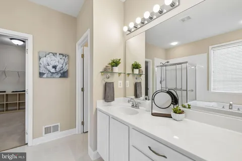 a bathroom with a sink double vanity and a mirror