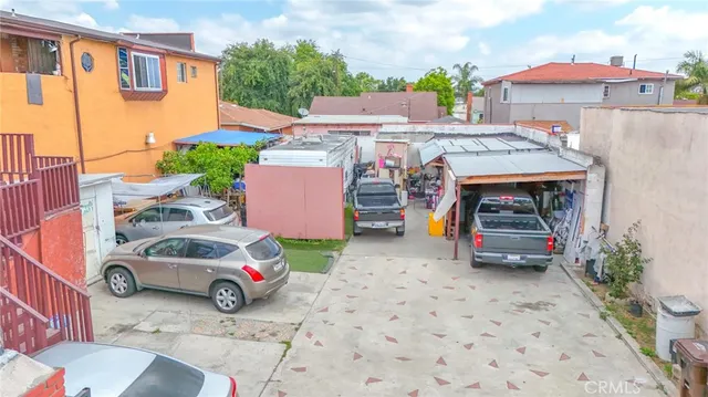 a view of a cars park in front of a building