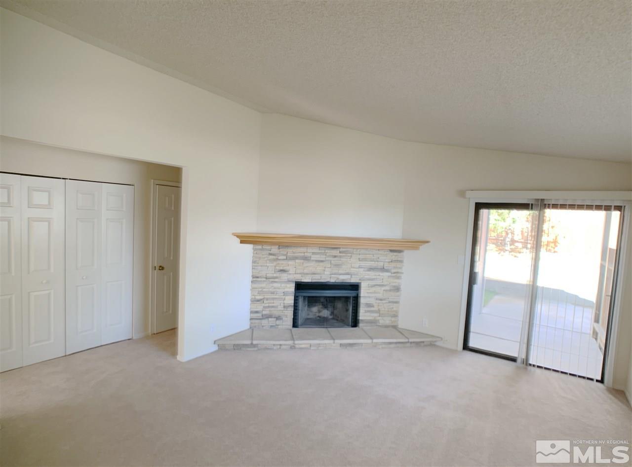 2101 Escalera Way Reno, NV 89523 - Photo 4 of 17 an empty room with large fireplace and a window