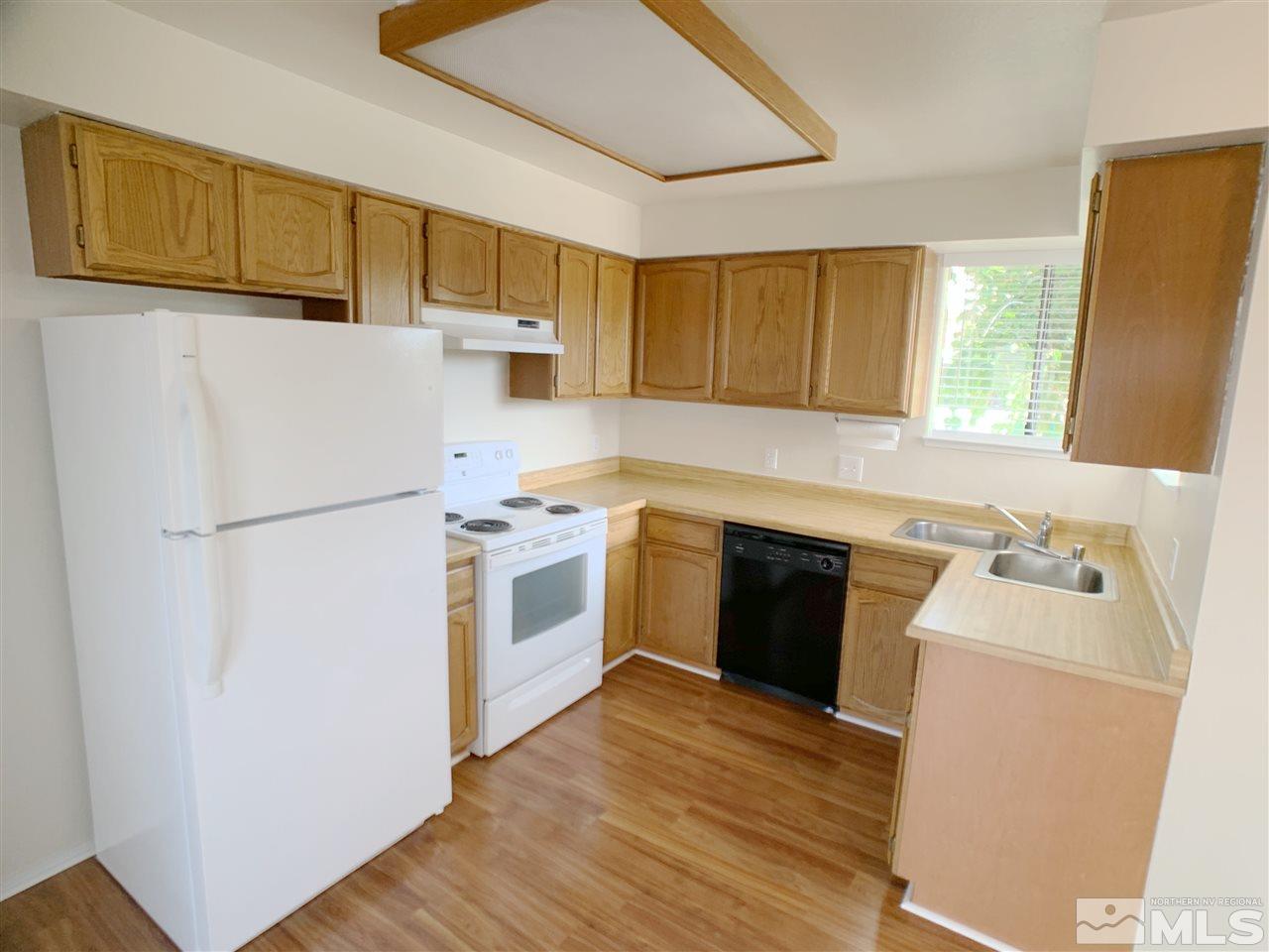 2101 Escalera Way Reno, NV 89523 - Photo 6 of 17 a kitchen with a refrigerator sink and cabinets