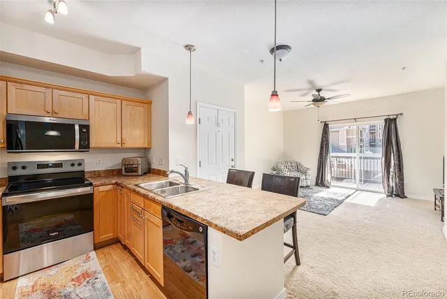 a kitchen with a stove a sink and a refrigerator