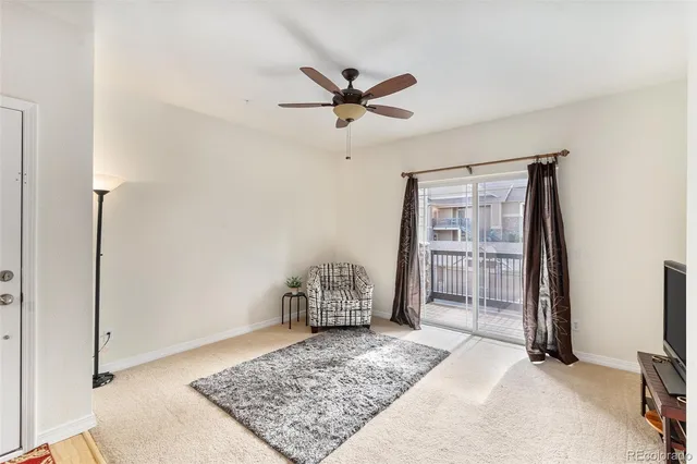 a living room with furniture and a rug