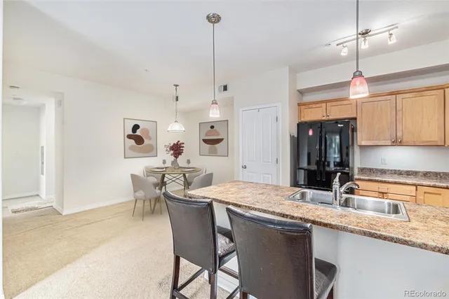 a kitchen with center island table and chairs