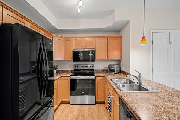 a kitchen with a sink stove and refrigerator