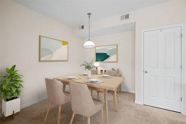 a dining room with furniture and a potted plant