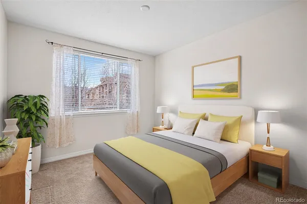 a bedroom with a bed and a potted plant