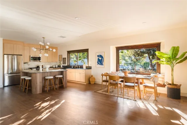 a bathroom with a sink a toilet a window and tub