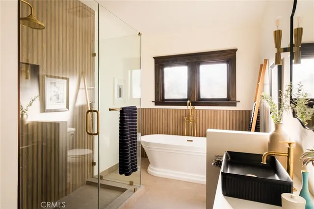 a bedroom with bed and a potted plant