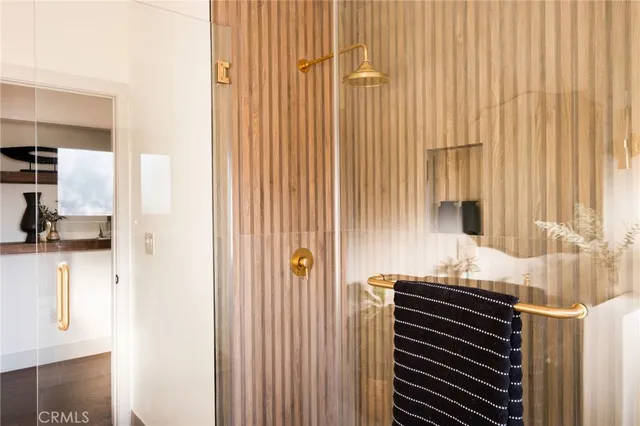 a bedroom with a large bed and a potted plant