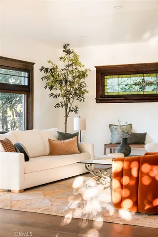 a living room with furniture and a floor to ceiling window